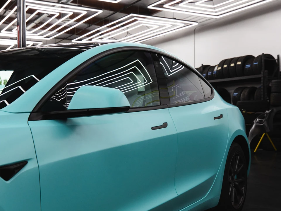 Turquoise sedan with black window surrounds and black door handles