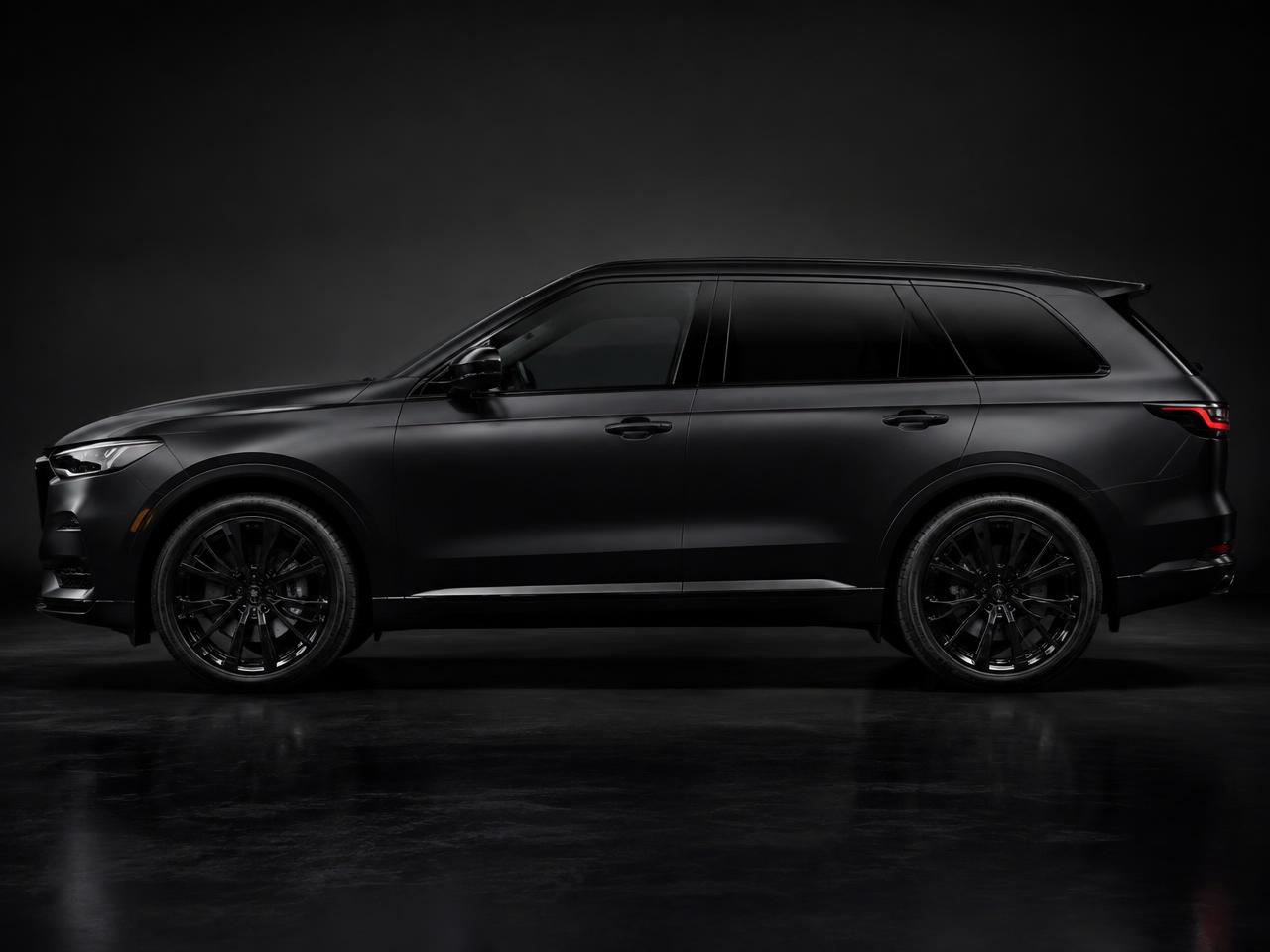 Matte black SUV in a dark studio